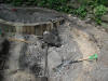 Tar binding together a large stone and concrete
